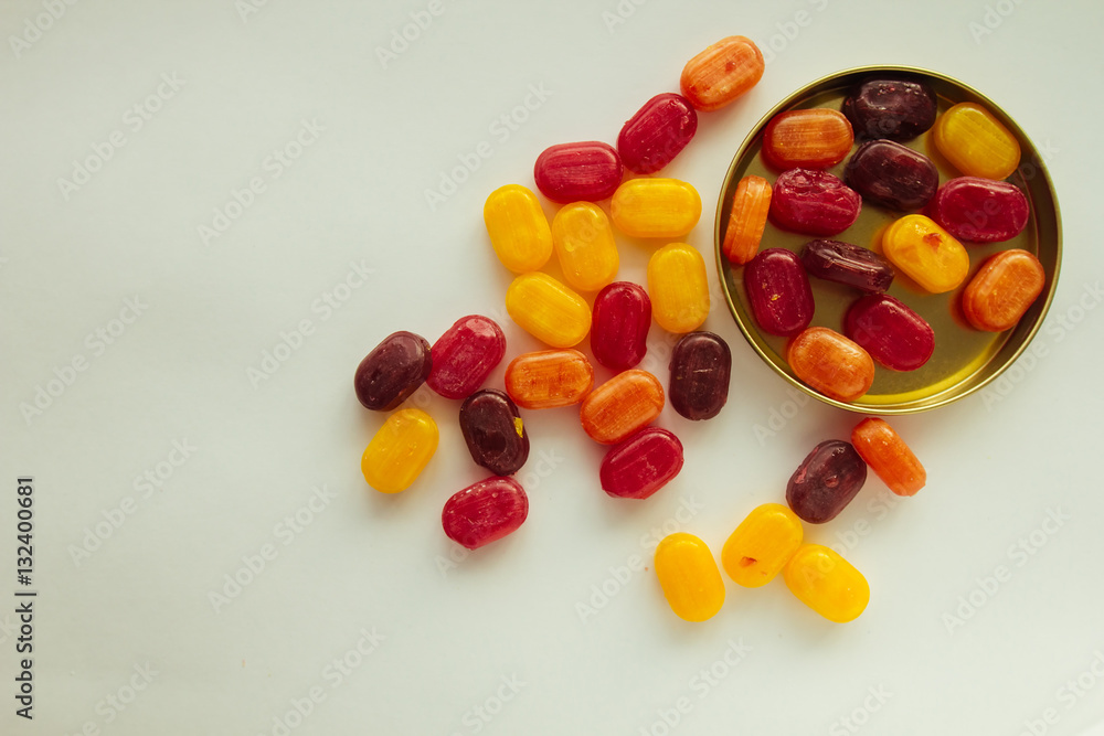 Multicolored candies in metal box top view Multicolored candies in metal box top view