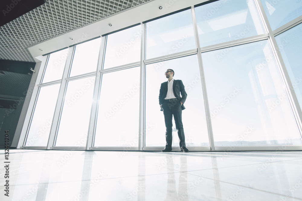 Fototapeta premium Confident business man neat panoramic windows