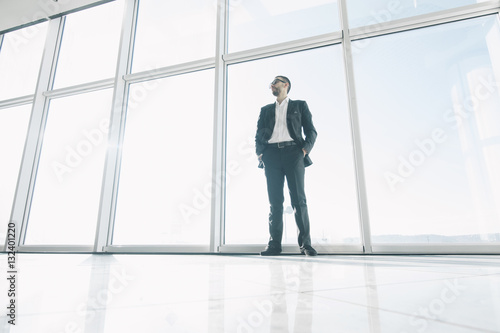 Confident business man neat panoramic windows