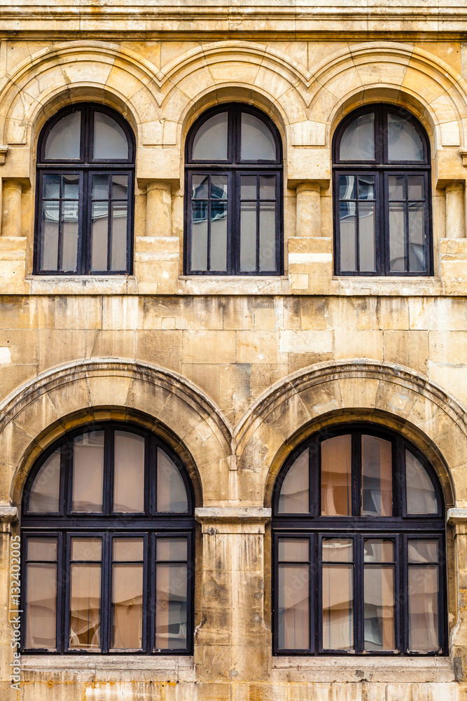 Color picture of five large arched windows on stone facade