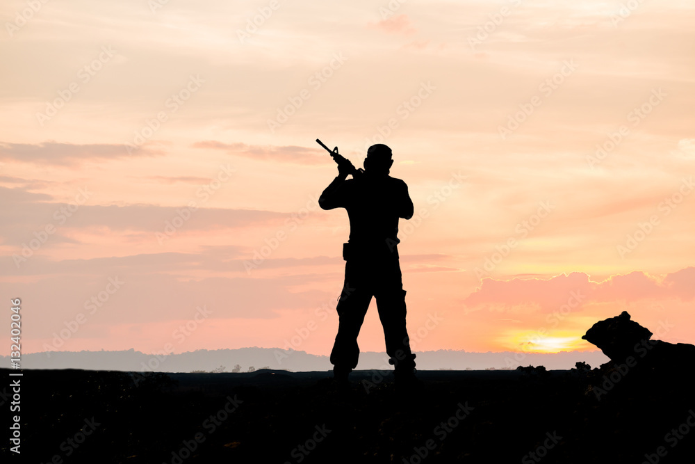 silhouette of soldier on the top of mountain at sunset silhouette of soldier on the top of mountain at sunset