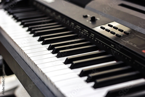 Piano close up black and white Piano keyboard background with selective focus, studio music synthesizer keyboard side view of instrument musical tool