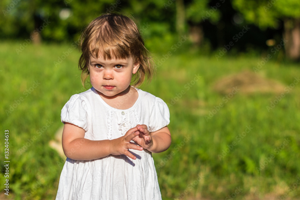 a little girl walks in the Park in summer a little girl walks in the Park in summer