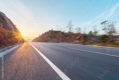 Motion blur highway with sunset or sunrise background.