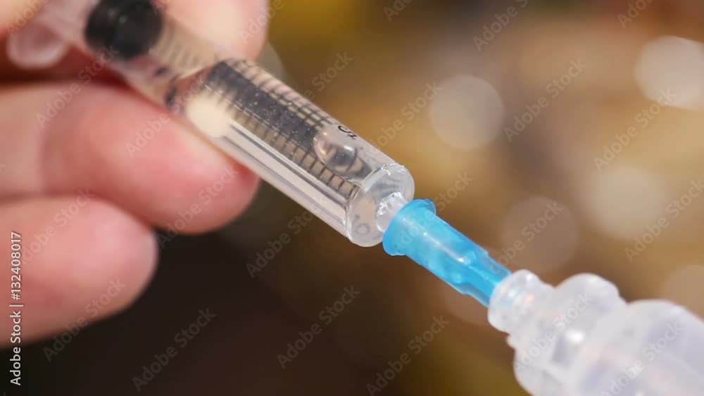 Syringe taking a liquid medicament from capsule. Syringe taking a liquid medicament from capsule.