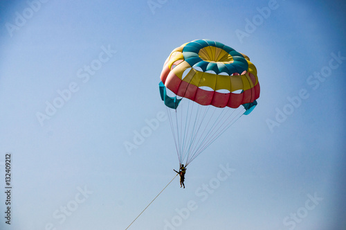Parachutist in the blue sky on a sunny day