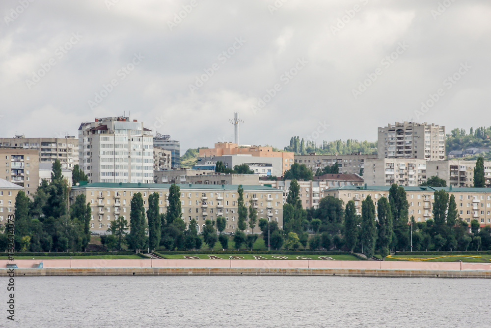 Panorama of the city of Saratov from the Volga river, Russia. Cloudy day, urban landscape, houses and buildings