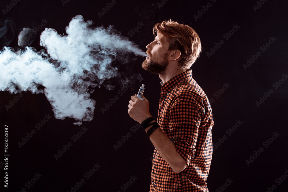 young man smoking electronic cigarette