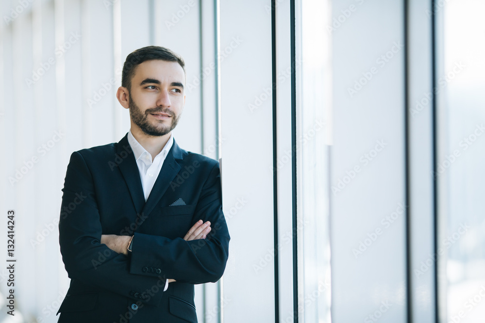 Handsome businessman in suit in office Handsome businessman in suit in office