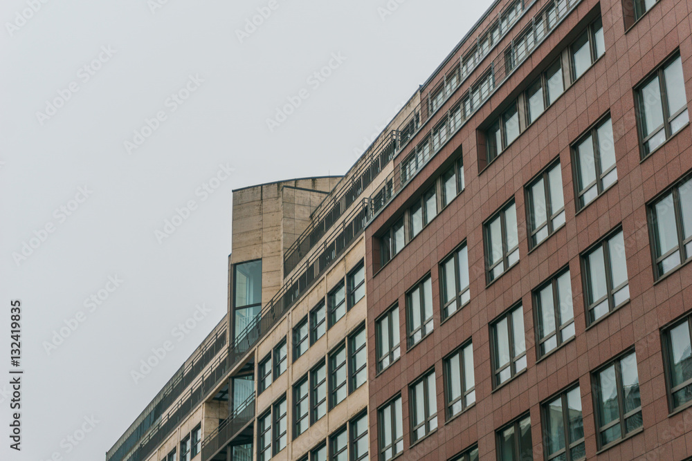 Fototapeta premium typical office buildings in a row on foggy day