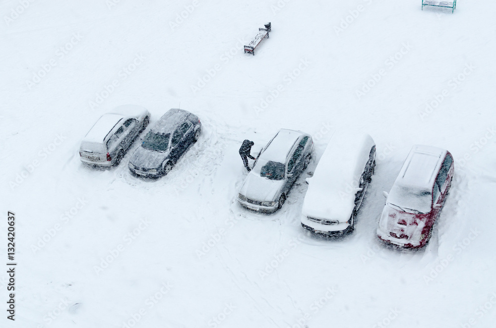 Top view of cars in yard during heavy snowfall Top view of cars in yard during heavy snowfall