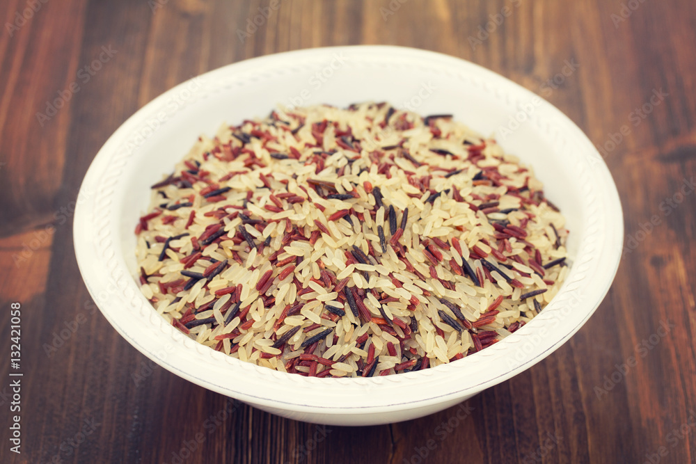 rice in white plate on wooden background rice in white plate on wooden background