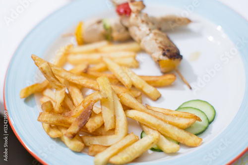 Tasty french fries with barbecue on child birthday