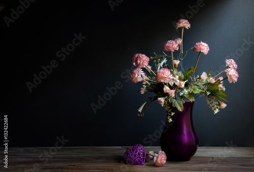 Carnations flowers in a Ceramic violet Vase
