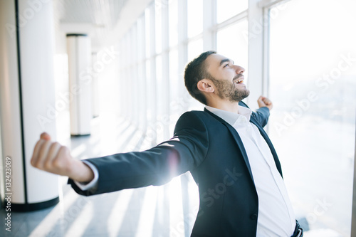 Incredible joy of businessman. Happy manager beside office window. Think about the jackpot.