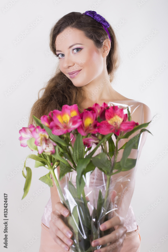 Beautiful happy girl give a wild orchid violet flowers