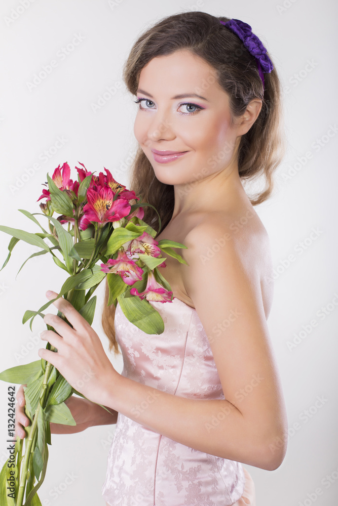 Beautiful happy girl give a wild orchid violet flowers Beautiful happy girl give a wild orchid violet flowers