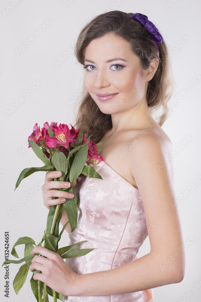 Beautiful happy girl give a wild orchid violet flowers Beautiful happy girl give a wild orchid violet flowers