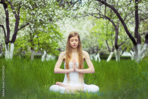 Wallpaper Mural beautiful woman is doing yoga in the blossoming garden Torontodigital.ca