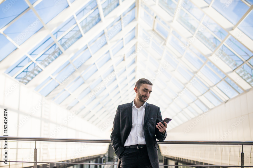 Boos look in his phone on his panoramic office