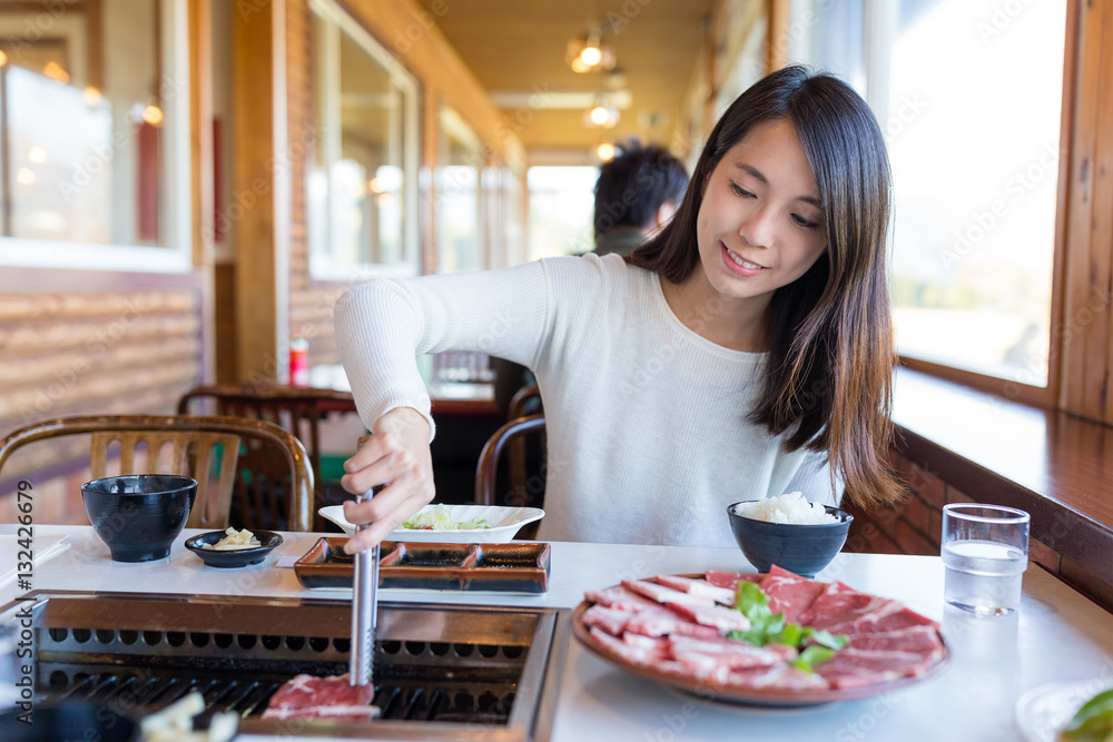 Woman enjoy roasted beef in japanese restaurant