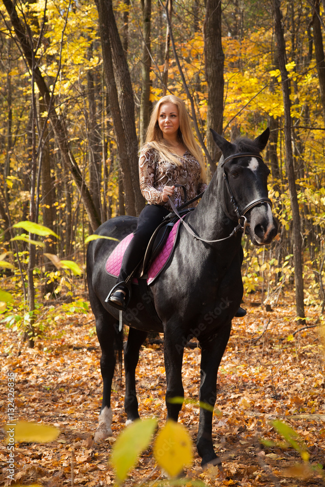 girl walking in the autumn forest on horseback girl walking in the autumn forest on horseback