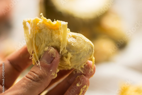 Fotografija Pulp of the piece of durian in the man's hand