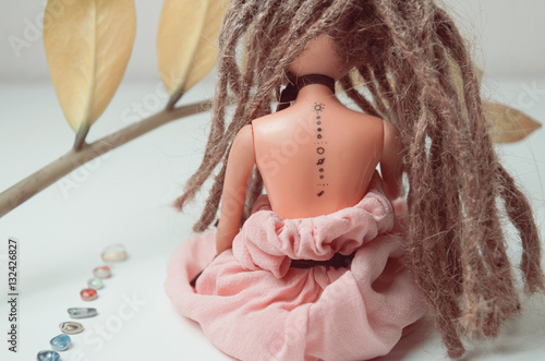 Doll with dreadlocks and tattoo with solar system