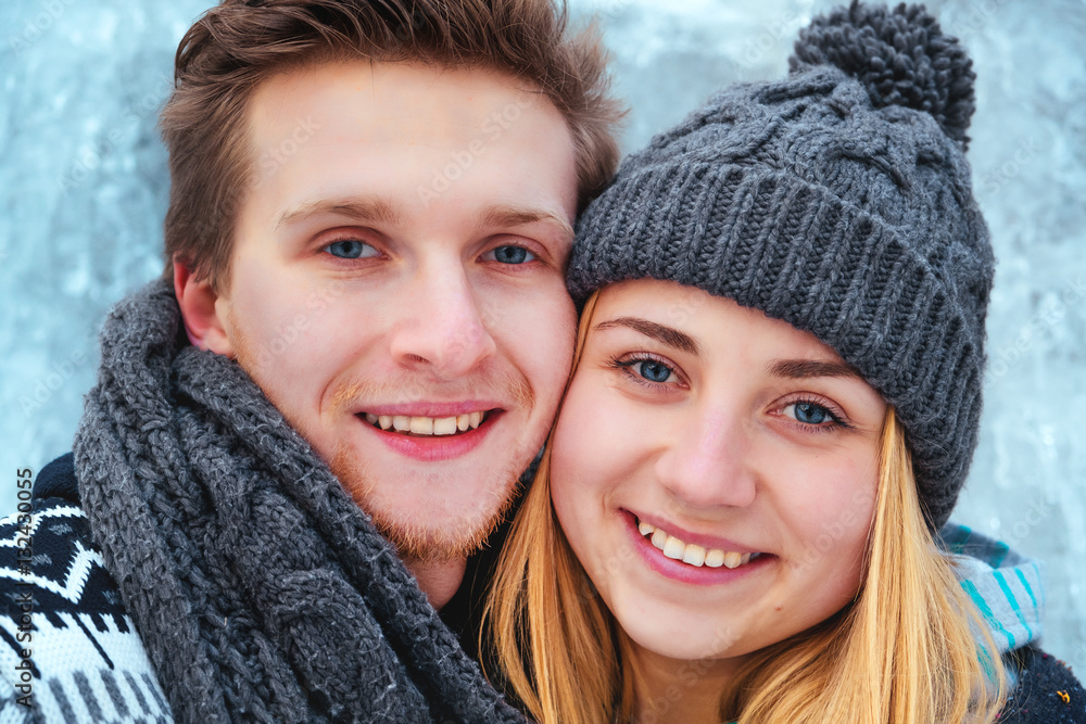 Winter couple piggyback in snow smiling happy and excited. Beautiful youngcouple close up Winter couple piggyback in snow smiling happy and excited. Beautiful youngcouple close up