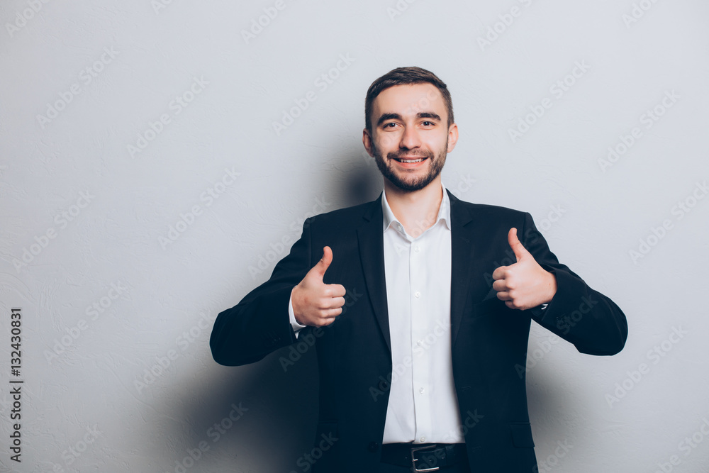Young businessman in suit thumbs up isolated Young businessman in suit thumbs up isolated
