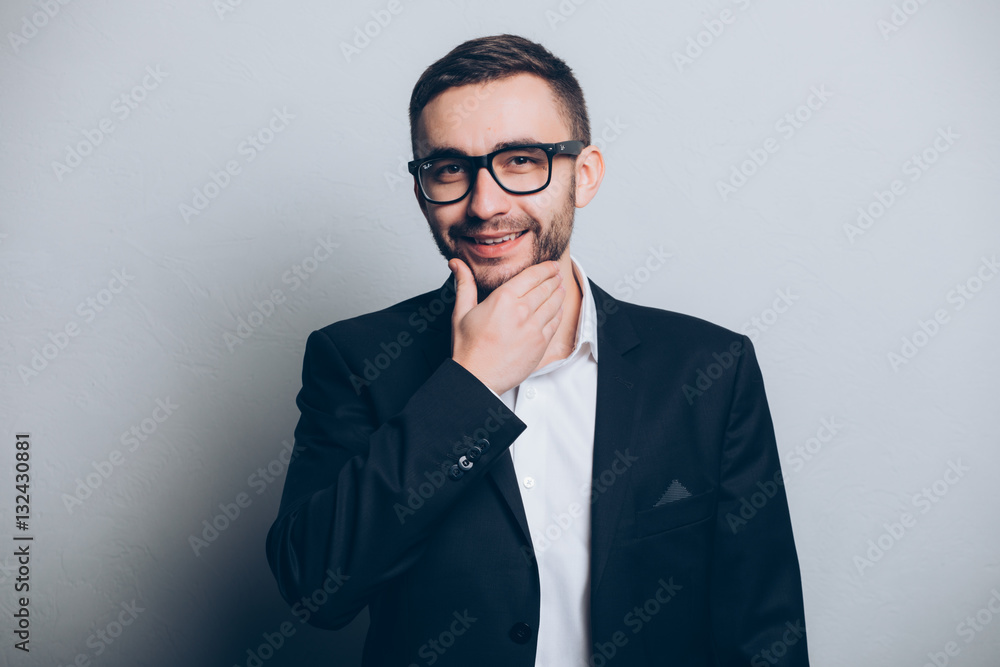 Young businessman in suit hand on beard isolated Young businessman in suit hand on beard isolated