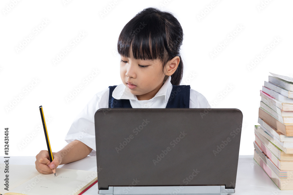 Asian Chinese little girl wearing school uniform study using lap Asian Chinese little girl wearing school uniform study using lap