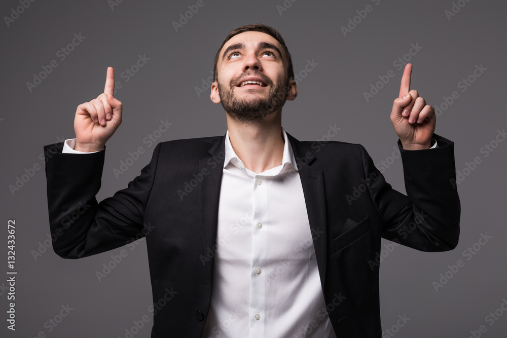 Young businessman in suit pointed and look up isolated Young businessman in suit pointed and look up isolated