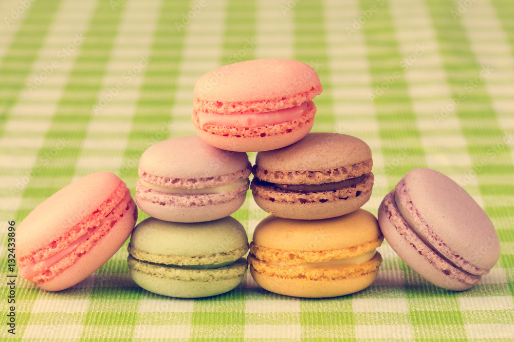 Fototapeta premium Macaroons stacked on checkered tablecloth