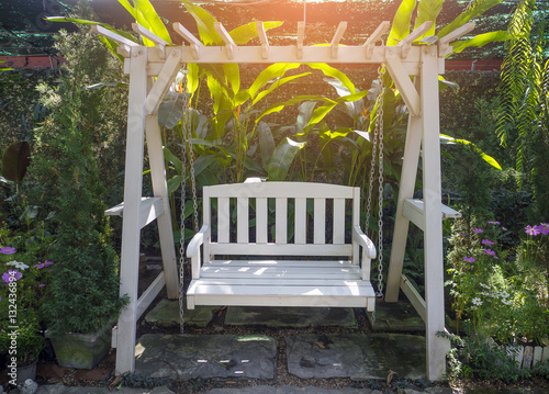 white wooden porch swing in garden