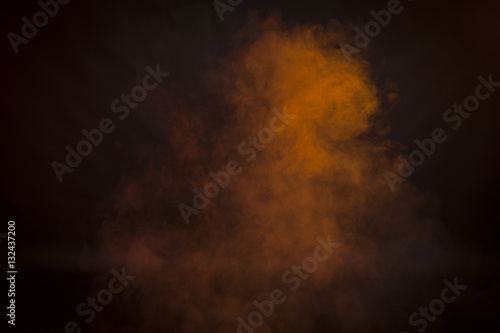 Orange smoke in a dark room. Texture, background 