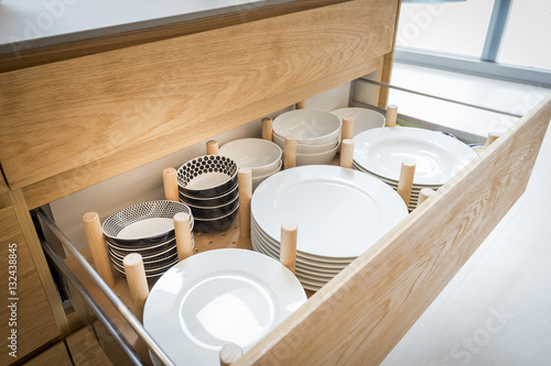 Fotografía Kitchen cupboard with opened drawer organizer