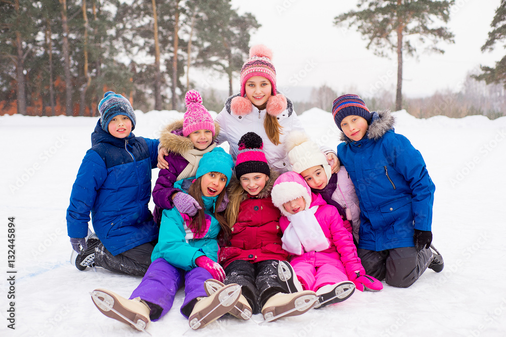 group of kids sitting on the ice