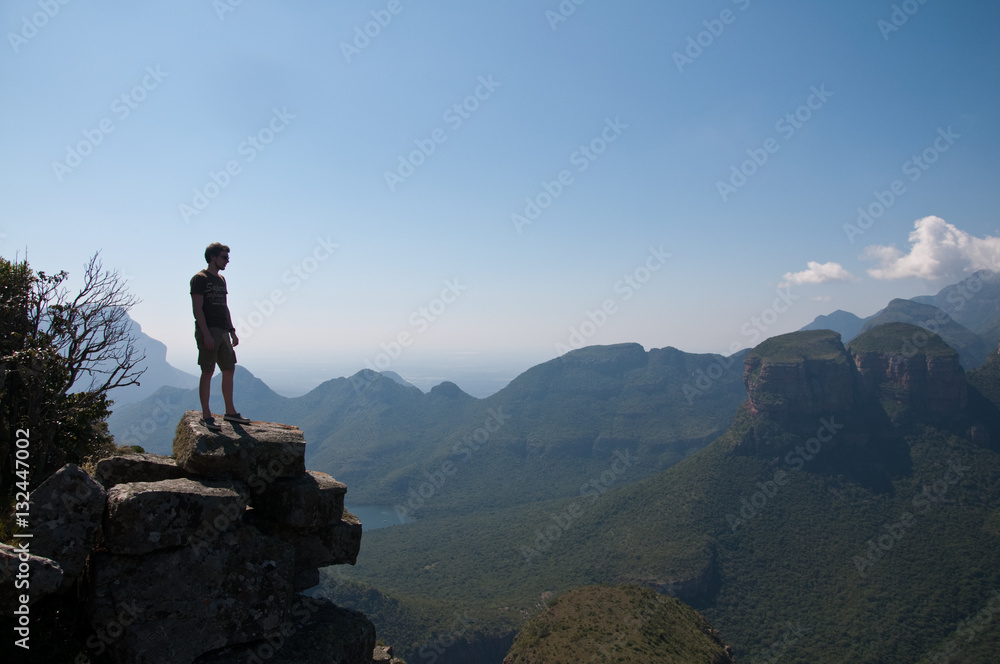 Man standing on the top of the cliff
