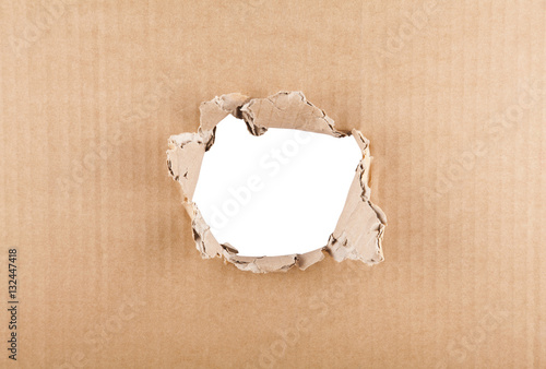 Ripped hole in cardboard on white background with clipping path photo