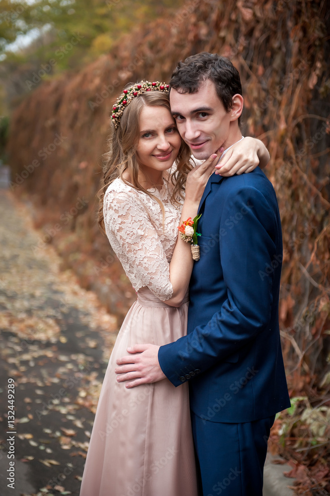 Portrait of happy newlyweds in autumn nature. Happy bride and gr Portrait of happy newlyweds in autumn nature. Happy bride and gr