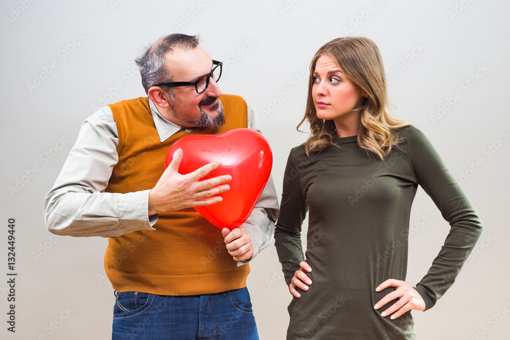 Nerdy man is uncertain in his girlfriend love.
Nerdy man is uncertain in his girlfriend love.