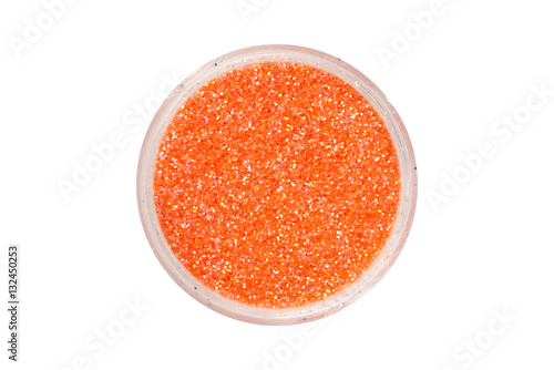Orange glitter particles in open container, view from above
