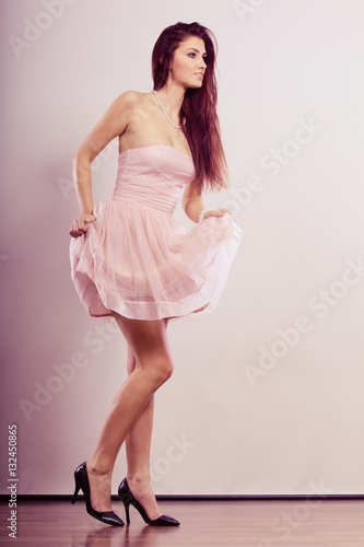 woman in bright dress and high heels shoes
