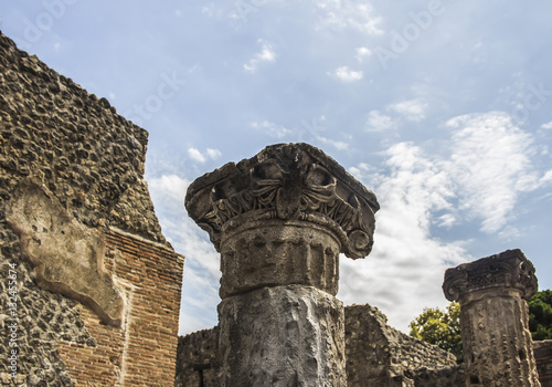 Ancient column, Corinthian order in Pompeii  city destroyed in 79BC by the eruption of Mount Vesuvius. The antique ruins and the vulcano near Naples, Italy photo
