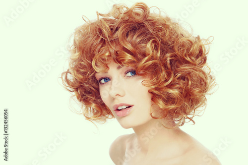 Vintage style portrait of young beautiful happy healthy woman with curly red hair 