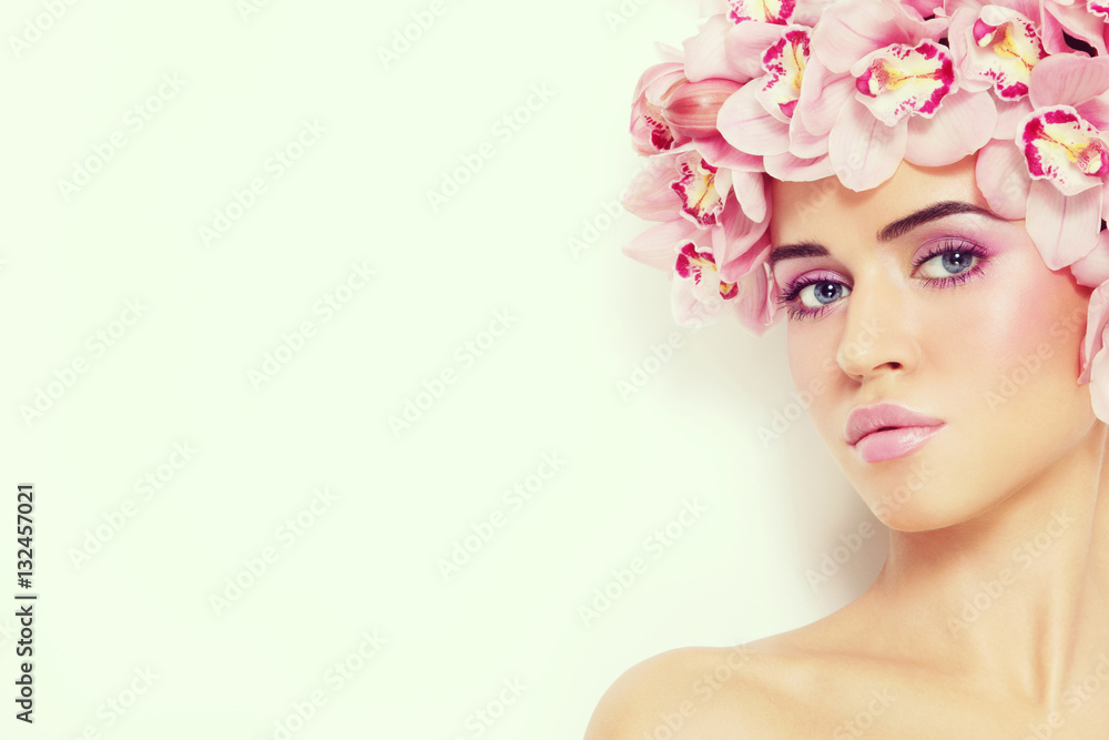 Vintage style portrait of young beautiful sexy woman with fresh make-up and orchids in her hair, copy space