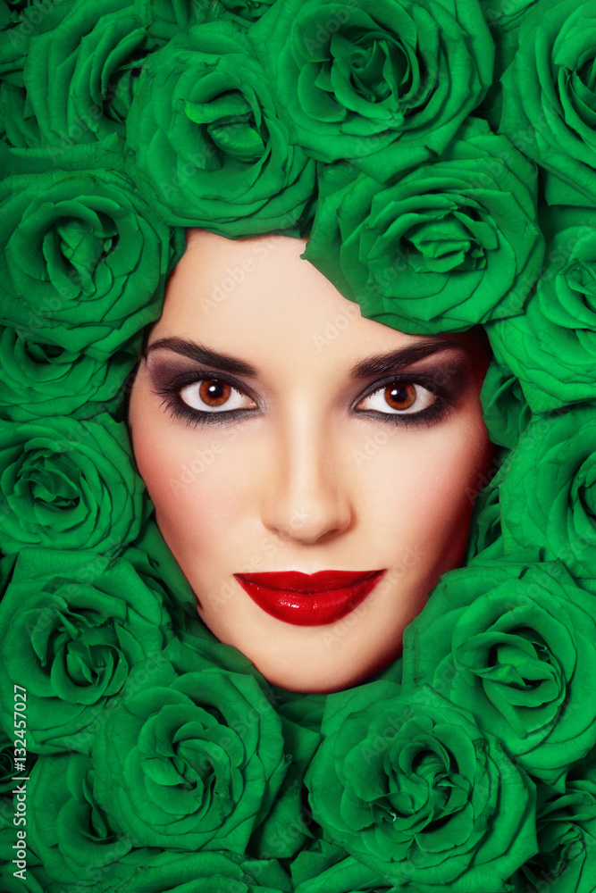 Vintage style close-up portrait of beautiful young girl with smoky eyes and green roses around her face