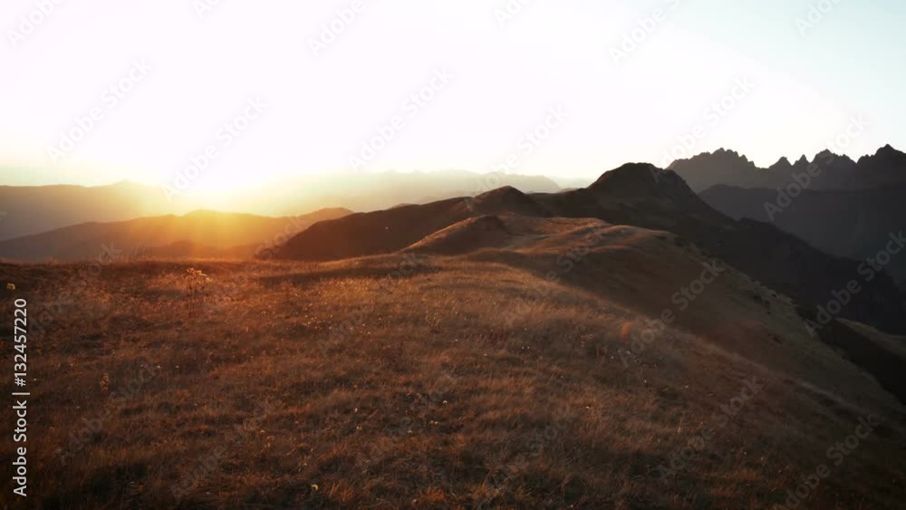 smooth motion along yellow autumn grass swaying in the wind, Golden mountain hills in sunset smooth motion along yellow autumn grass swaying in the wind, Golden mountain hills in sunset