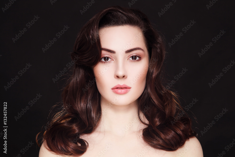 Fototapeta premium Portrait of beautiful young woman with clean make-up and long curly hair